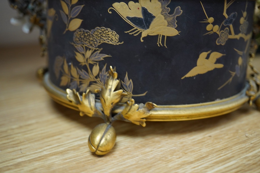A French ormolu and lacquered jardiniere with porcelain mounted handles, stamped 'Bointaburet A Paris', together with a ‘pear’ candle display. Jardiniere width 23cm. Condition - one handle damaged, interior rubbed